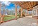 An outdoor covered patio featuring brick pillars and wooden railings, offering a spacious outdoor area at 13833 Jonathans Ridge Rd, Mint Hill, NC 28227