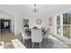 Bright dining room featuring contemporary chandelier, ample seating, and natural light at 13833 Jonathans Ridge Rd, Mint Hill, NC 28227