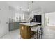 Bright kitchen with white cabinetry, granite countertops, and a charming wood-accented island at 13833 Jonathans Ridge Rd, Mint Hill, NC 28227
