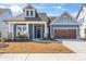 Charming home featuring a two-car garage, covered porch, and manicured front lawn at 1447 Encore Ln, Waxhaw, NC 28173