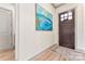 Bright foyer featuring hardwood floors, decorative rug, artwork, and stylish entryway at 1447 Encore Ln, Waxhaw, NC 28173