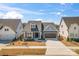 Charming blue craftsman home with a well-manicured front yard and attached garage at 1447 Encore Ln, Waxhaw, NC 28173