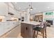 Modern kitchen with white cabinets, large center island, pendant lighting, and hardwood floors at 1447 Encore Ln, Waxhaw, NC 28173