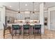 Stylish kitchen with white cabinets, large center island, modern appliances and bar stool seating at 1447 Encore Ln, Waxhaw, NC 28173