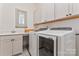 Functional laundry room with modern washer and dryer, plus ample storage at 1447 Encore Ln, Waxhaw, NC 28173