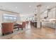 Open concept living space with hardwood floors, and seamless flow between living room, dining, and kitchen at 1447 Encore Ln, Waxhaw, NC 28173
