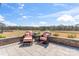 Charming outdoor patio with stone flooring and seating overlooking a scenic field at 1447 Encore Ln, Waxhaw, NC 28173