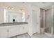 Bathroom featuring a double sink vanity, granite countertop, and a large tiled shower at 15616 Parkside Crossing Dr, Charlotte, NC 28278