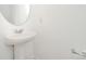 Modern powder room features a pedestal sink, round mirror, and clean design at 15616 Parkside Crossing Dr, Charlotte, NC 28278