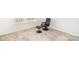Bright, carpeted bedroom featuring a black executive chair and matching ottoman next to a window at 15616 Parkside Crossing Dr, Charlotte, NC 28278