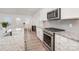 Well-appointed kitchen featuring stainless steel appliances, white cabinetry, and granite countertops at 15616 Parkside Crossing Dr, Charlotte, NC 28278