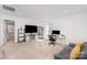 Spacious living room with comfortable seating, a dedicated workspace, and ample natural light at 15616 Parkside Crossing Dr, Charlotte, NC 28278