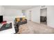 Open loft area with gray sofa, desk, and convenient access to the laundry room at 15616 Parkside Crossing Dr, Charlotte, NC 28278