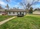 Exterior shot shows a well-maintained lawn and a house with gray siding at 1638 Pineburr Ln, Rock Hill, SC 29730