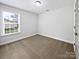 Neutral bedroom features a large window with ample natural light and neutral carpet at 1638 Pineburr Ln, Rock Hill, SC 29730