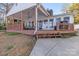 Charming back porch with ample seating, ceiling fan, and a swing, ideal for relaxation and outdoor entertaining at 1657 Bowater Rd, Rock Hill, SC 29732