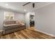 Bright bedroom featuring wood floors, a daybed, and an adjoining laundry closet with a washer and dryer at 1657 Bowater Rd, Rock Hill, SC 29732