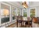 Bright dining room featuring large windows, stylish lighting, and hardwood table with chairs at 1657 Bowater Rd, Rock Hill, SC 29732