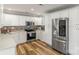 Modern kitchen featuring stainless steel appliances, white cabinetry, and stylish backsplash at 1657 Bowater Rd, Rock Hill, SC 29732