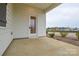Covered back patio features concrete flooring and a door leading inside the home at 1814 Saint Louis Nw Aly, Concord, NC 28027