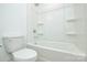 Bright white bathroom featuring a shower-tub combo and modern fixtures at 1814 Saint Louis Nw Aly, Concord, NC 28027