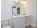 This bathroom features a dual sink vanity, quartz countertops, and wood-look floors at 1814 Saint Louis Nw Aly, Concord, NC 28027