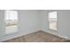 Bedroom with neutral carpet and bright windows offering neighborhood views at 1814 Saint Louis Nw Aly, Concord, NC 28027