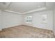 A spacious bedroom boasts tray ceilings and natural light from large windows at 1814 Saint Louis Nw Aly, Concord, NC 28027