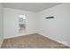 This carpeted bedroom features a neighborhood view from the window at 1814 Saint Louis Nw Aly, Concord, NC 28027