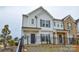Charming two-story home features a black metal fence, neutral siding and trim, and an inviting facade at 1814 Saint Louis Nw Aly, Concord, NC 28027