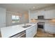 Bright kitchen featuring quartz counters, island, and stainless steel appliances at 1814 Saint Louis Nw Aly, Concord, NC 28027