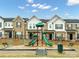 Community playground offers a fun space for with slides and climbing structures near townhome buildings at 1814 Saint Louis Nw Aly, Concord, NC 28027
