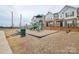 Community playground with slides and a fenced area, perfect for outdoor activities at 1814 Saint Louis Nw Aly, Concord, NC 28027