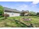 A home's backyard featuring a covered patio and grassy lawn at 1838 Summit Ridge Ln, Kannapolis, NC 28083