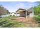 Backyard featuring a covered patio, a grassy lawn, and some wood storage at 1838 Summit Ridge Ln, Kannapolis, NC 28083
