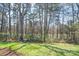 This home features a picturesque backyard bordering a serene wooded area and lake at 1838 Summit Ridge Ln, Kannapolis, NC 28083