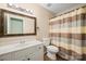 Bathroom featuring a large mirror, striped shower curtain, and white vanity at 1838 Summit Ridge Ln, Kannapolis, NC 28083