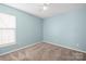 Bedroom featuring blue walls, neutral carpet, and a bright window at 1838 Summit Ridge Ln, Kannapolis, NC 28083