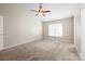 Spacious carpeted bedroom featuring a vaulted ceiling, ceiling fan, and a window at 1838 Summit Ridge Ln, Kannapolis, NC 28083