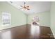 Bright bedroom with hardwood floors, ceiling fan, window, and sliding glass door to outside at 1838 Summit Ridge Ln, Kannapolis, NC 28083