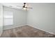Bedroom featuring neutral carpet, a ceiling fan, and a bright window at 1838 Summit Ridge Ln, Kannapolis, NC 28083