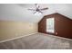 Upstairs bonus room featuring neutral carpet, a window, and brown accent wall at 1838 Summit Ridge Ln, Kannapolis, NC 28083