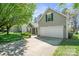 Charming home featuring a two-car garage, lovely lawn and mature tree at 1838 Summit Ridge Ln, Kannapolis, NC 28083