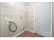 Laundry room featuring tile flooring, a wire rack, and a white door at 1838 Summit Ridge Ln, Kannapolis, NC 28083