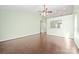 Bright living room with hardwood floors and a ceiling fan, open to kitchen with bar seating at 1838 Summit Ridge Ln, Kannapolis, NC 28083