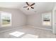 Large bedroom with vaulted ceiling, neutral walls, plush carpeting, ceiling fan, and sunny windows at 206 W 19Th St, Kannapolis, NC 28081