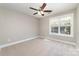Light and bright bedroom with neutral walls, plush carpeting, ceiling fan, and sunny window at 206 W 19Th St, Kannapolis, NC 28081
