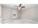 Bedroom with neutral walls, plush carpeting, ceiling fan, and large sunny window at 206 W 19Th St, Kannapolis, NC 28081