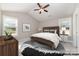 Bright bedroom features a wooden bed frame, vaulted ceilings, two windows and neutral decor at 206 W 19Th St, Kannapolis, NC 28081