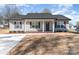 Charming gray home with a black roof, complemented by professionally landscaped yard and a spacious concrete driveway at 206 W 19Th St, Kannapolis, NC 28081